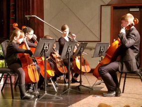 Nathaniel guides students in a concert.