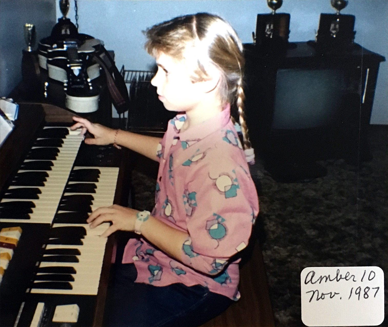 Amber playing the organ in her home - 10 years old.